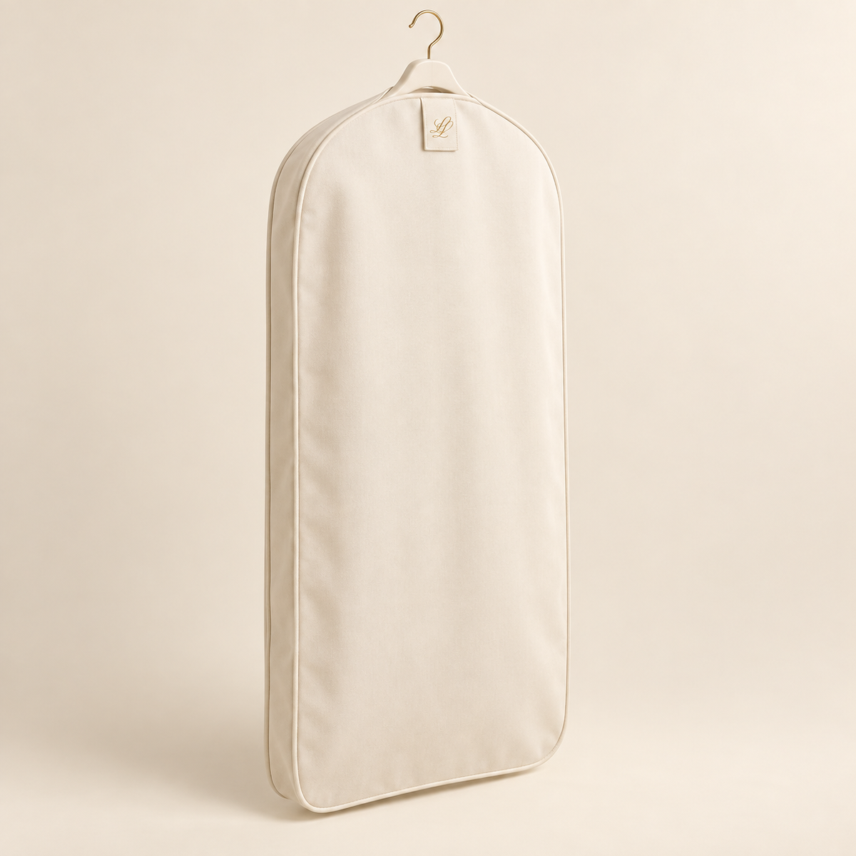 Warm-ivory full-length garment cover with champagne-gold hook and discreet gold LL woven tab on a neutral studio background.